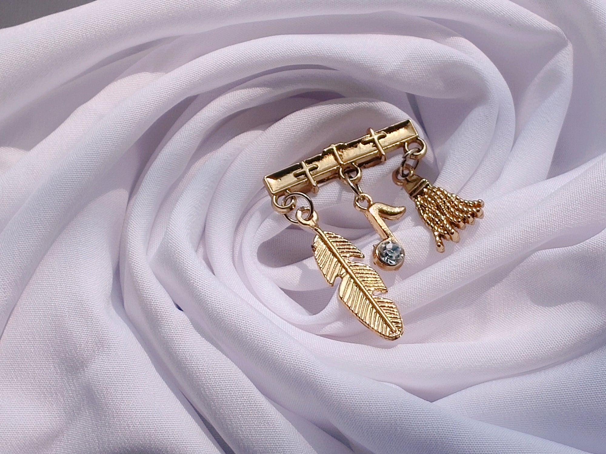 Brooch with Hanging Feather, Musical Note and Broom