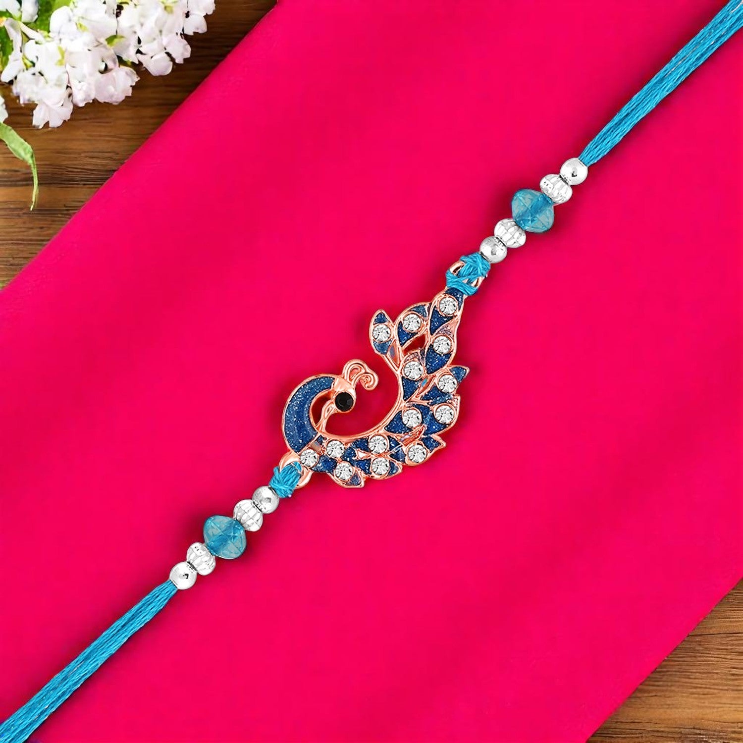Rose Gold Plated Blue Glossy Meenakari Work Peacock-Shaped Fancy Rakhi