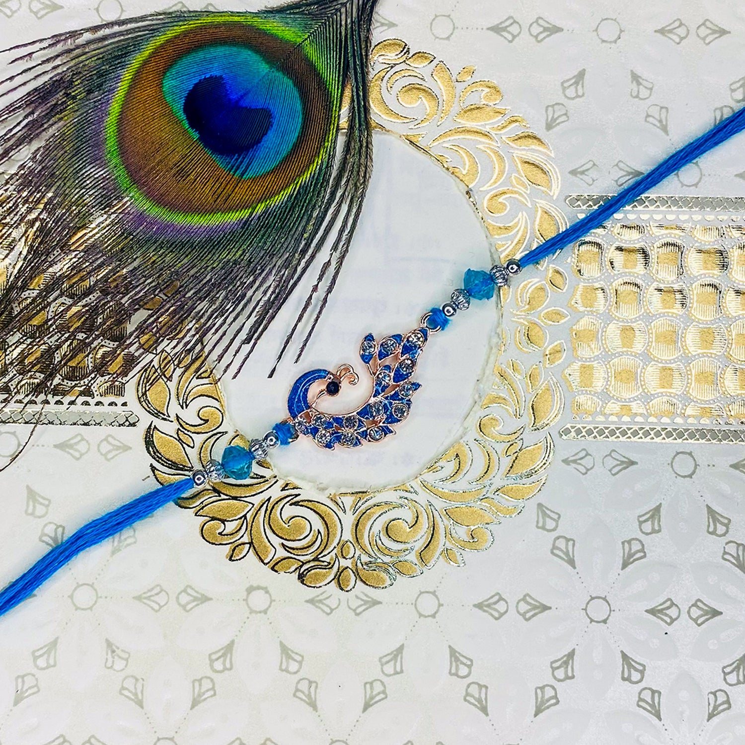 Rose Gold Plated Blue Glossy Meenakari Work Peacock-Shaped Fancy Rakhi