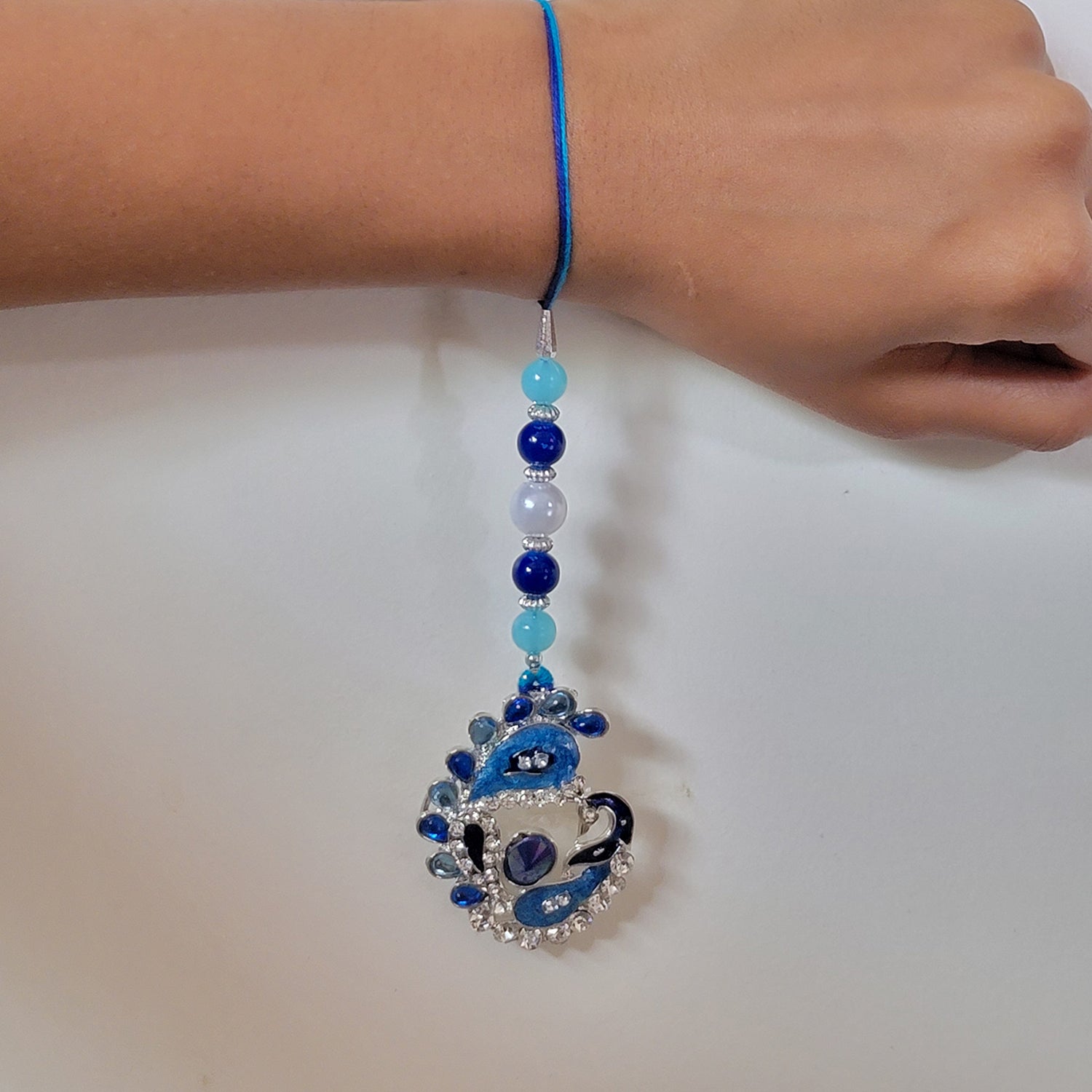 Blue Meenakari Work Peacock Shaped Lumba Rakhi