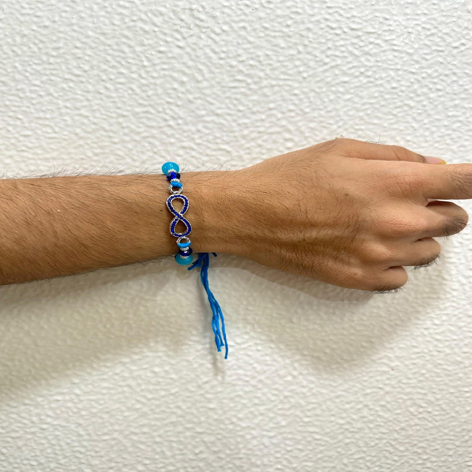 Infinity Shape Blue Crystal Studed Lumba Rakhi