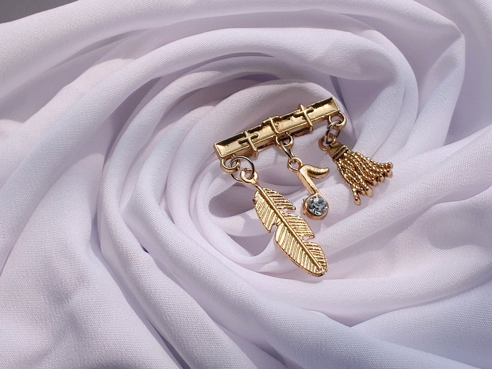 Brooch with Hanging Feather, Musical Note and Broom
